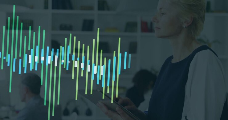 Holding tablet, woman in navy top tapping screen in office while waveform growing, copy space