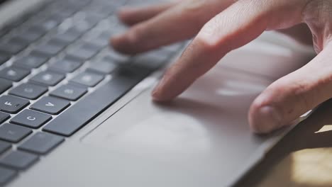 man is pinching and zooming on touchpad