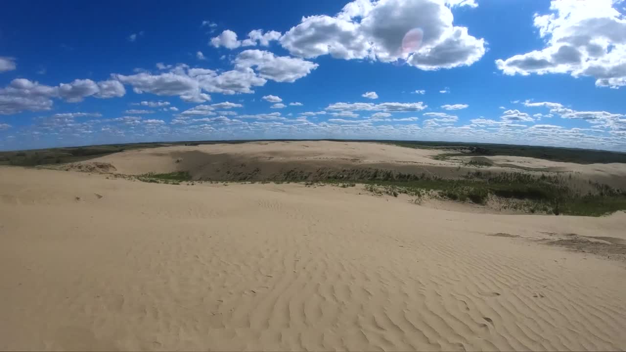 Desert sand at a sand dune on a cloudy sunny day in Alberta Canada looking at the skyline