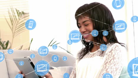 Animation-of-network-of-connections-with-icons-over-african-american-businesswoman-using-tablet