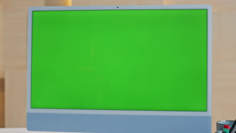 green screen computer placed at empty workplace close up. modern mockup monitor