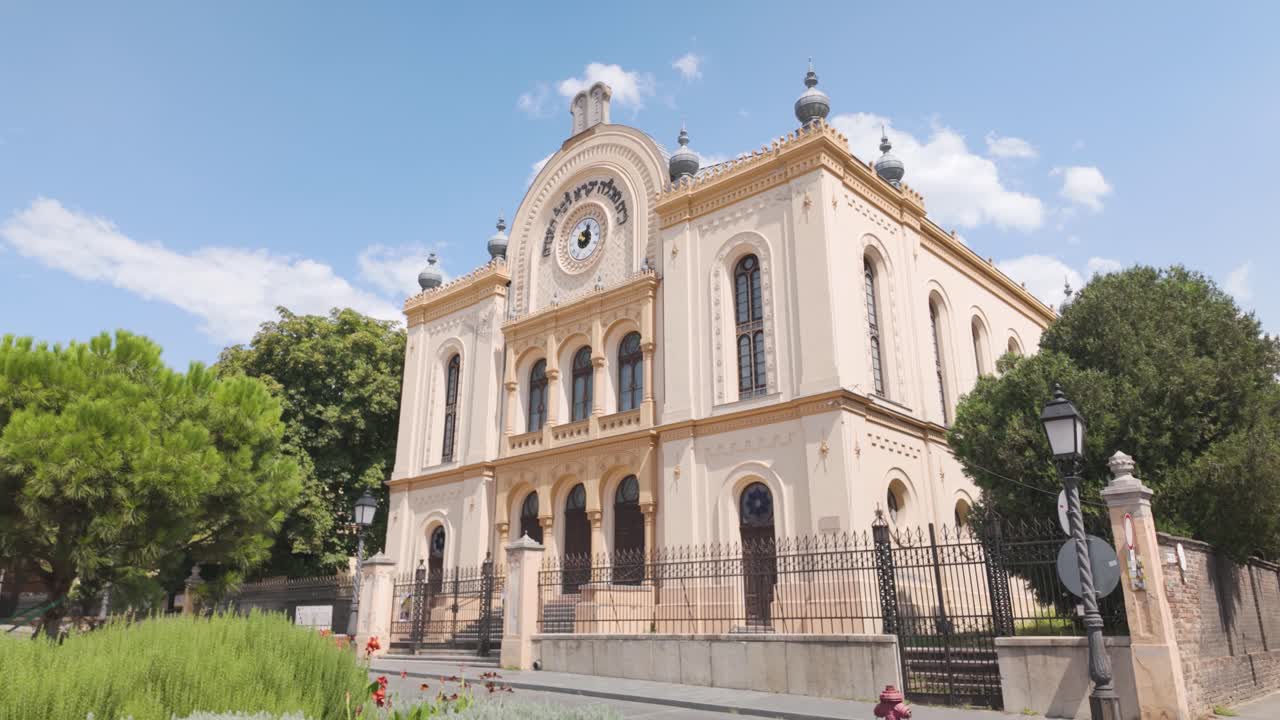Exterior view capturing the synagogue in Pécs, emphasizing architectural and decorative details