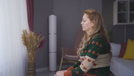 worried mature woman at home overwhelmed by anxiety and loneliness.