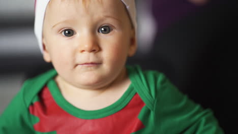 adorable bebé con grandes ojos brillantes disfrazado de duende lindo para navidad