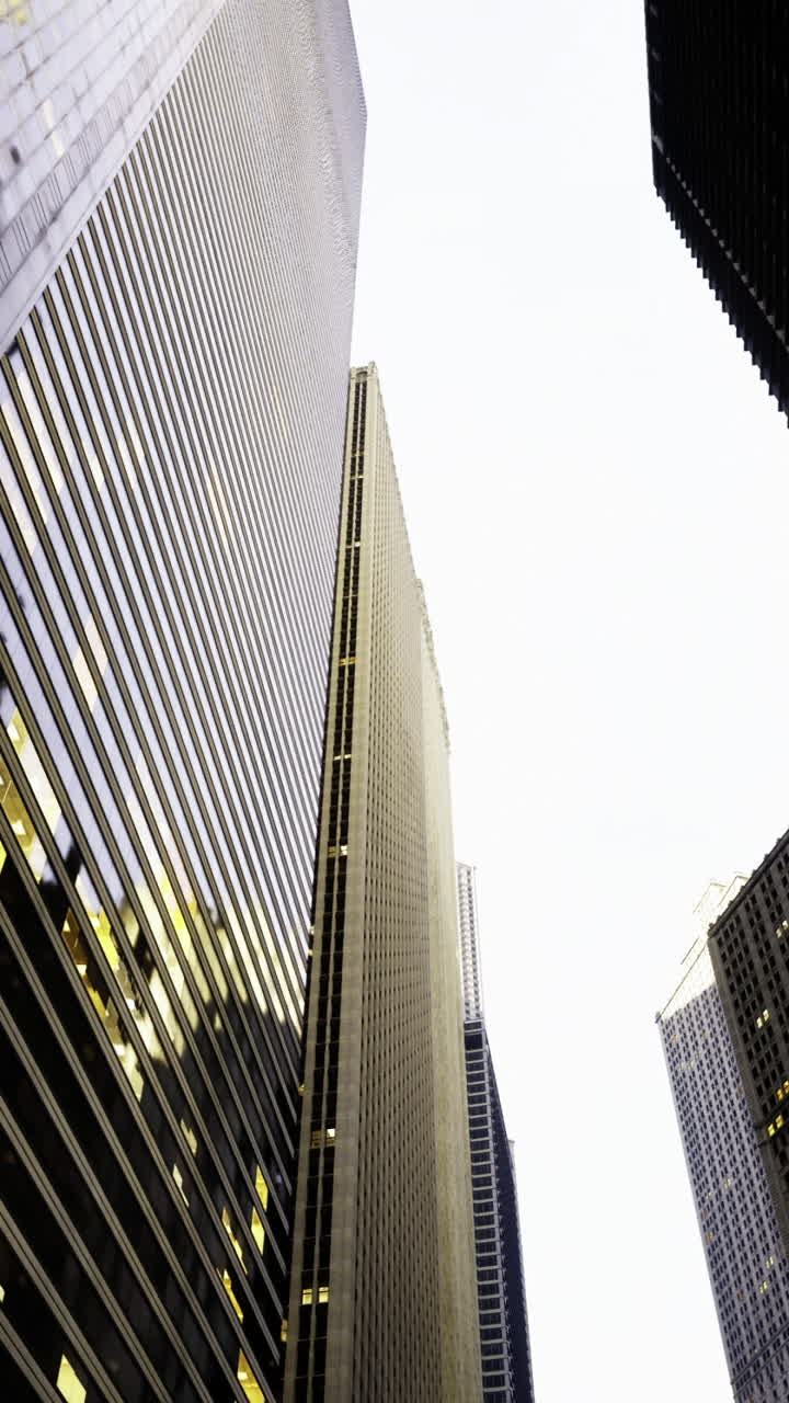 Explore the towering skyscrapers reflecting evening light in the city