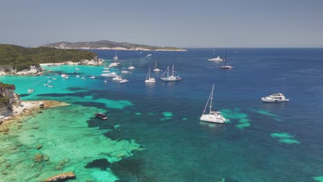 flyover expensive yachts in shallow turquoise water, parga greece