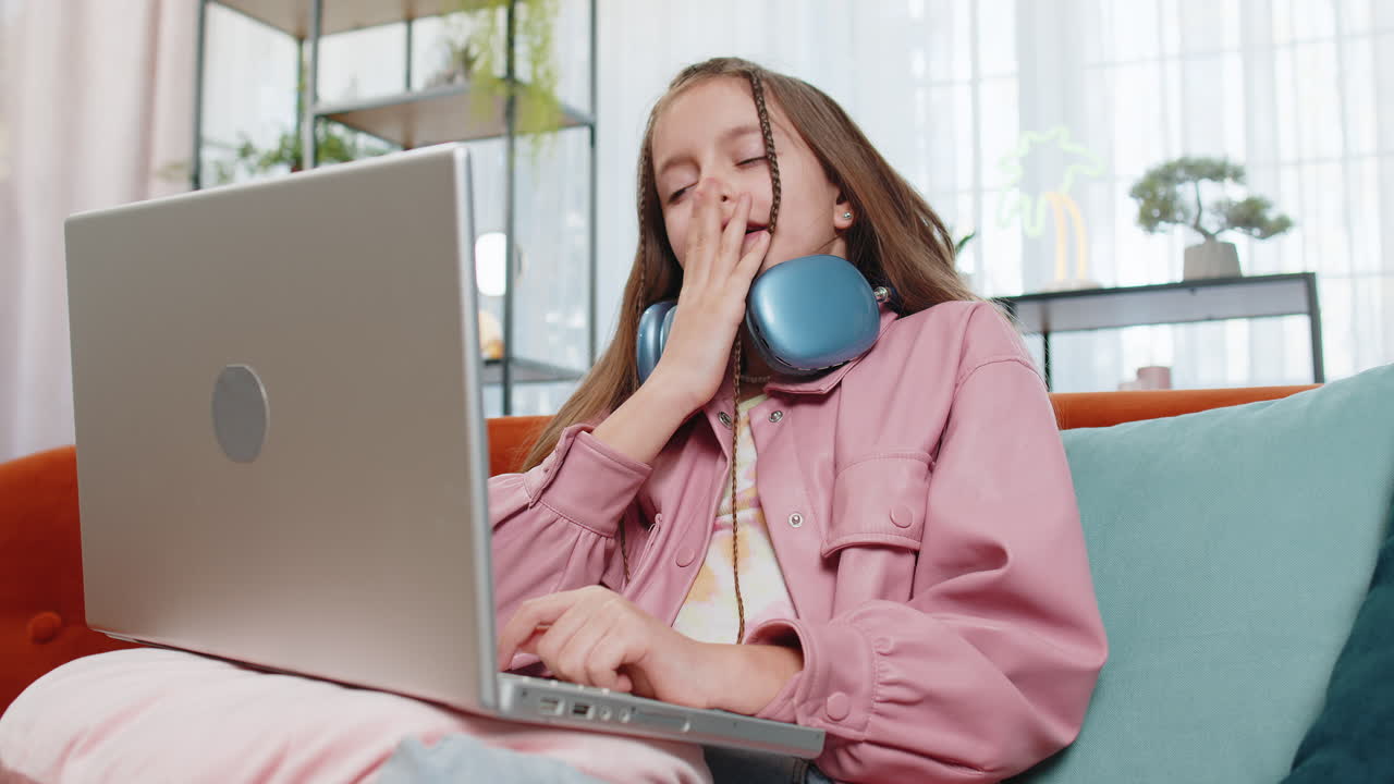 Tired young pupil girl feeling boring with education study or work at home on laptop computer
