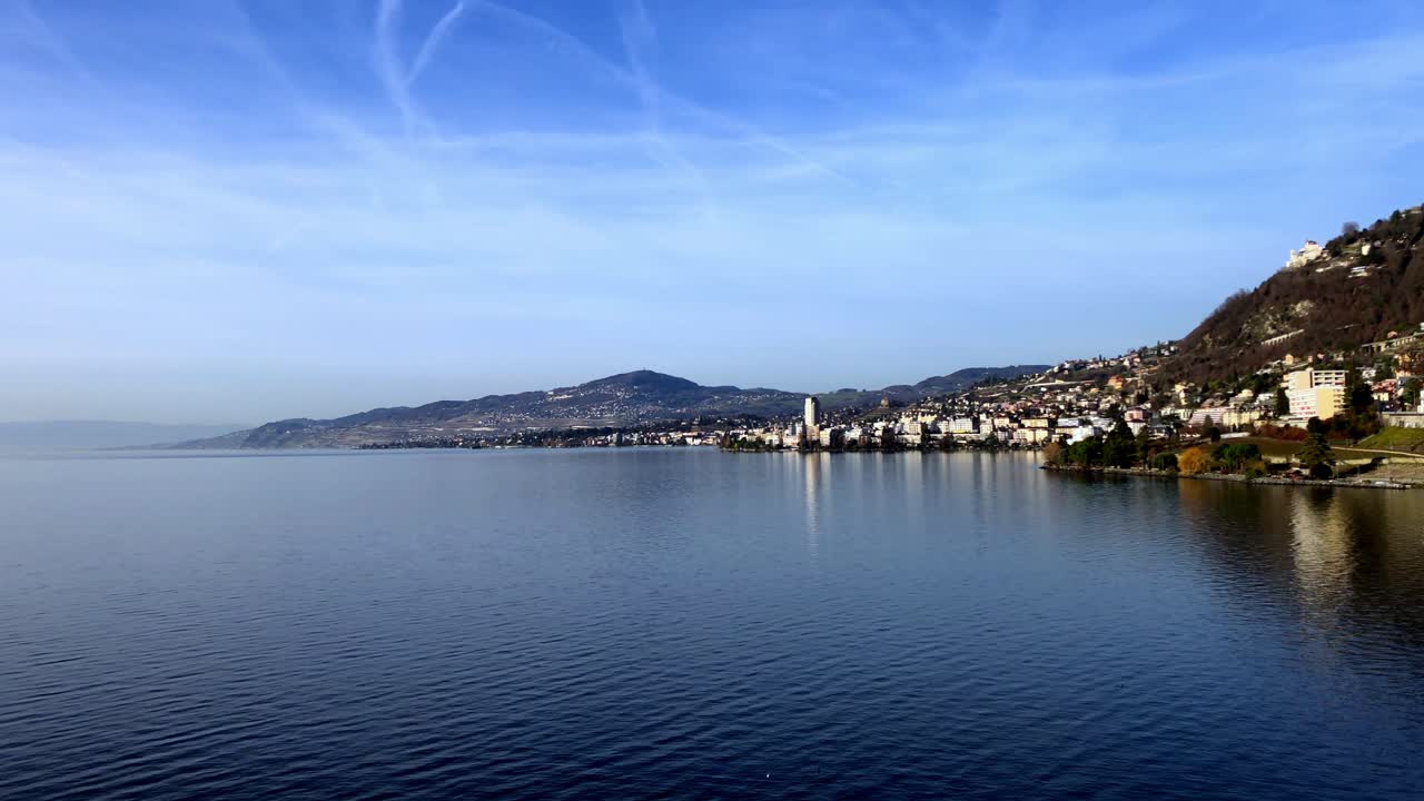Slow pan of Lake Geneva from Chillon Castle showing the shoreline city of Veytaux