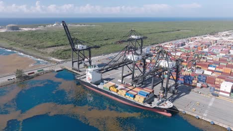 Cargo-Ship-At-Loading-Bay-Of-Container-Terminal-Of-Multimodal-Caucedo-Port-In-Boca-Chica,-Santo-Domingo,-Dominican-Republic