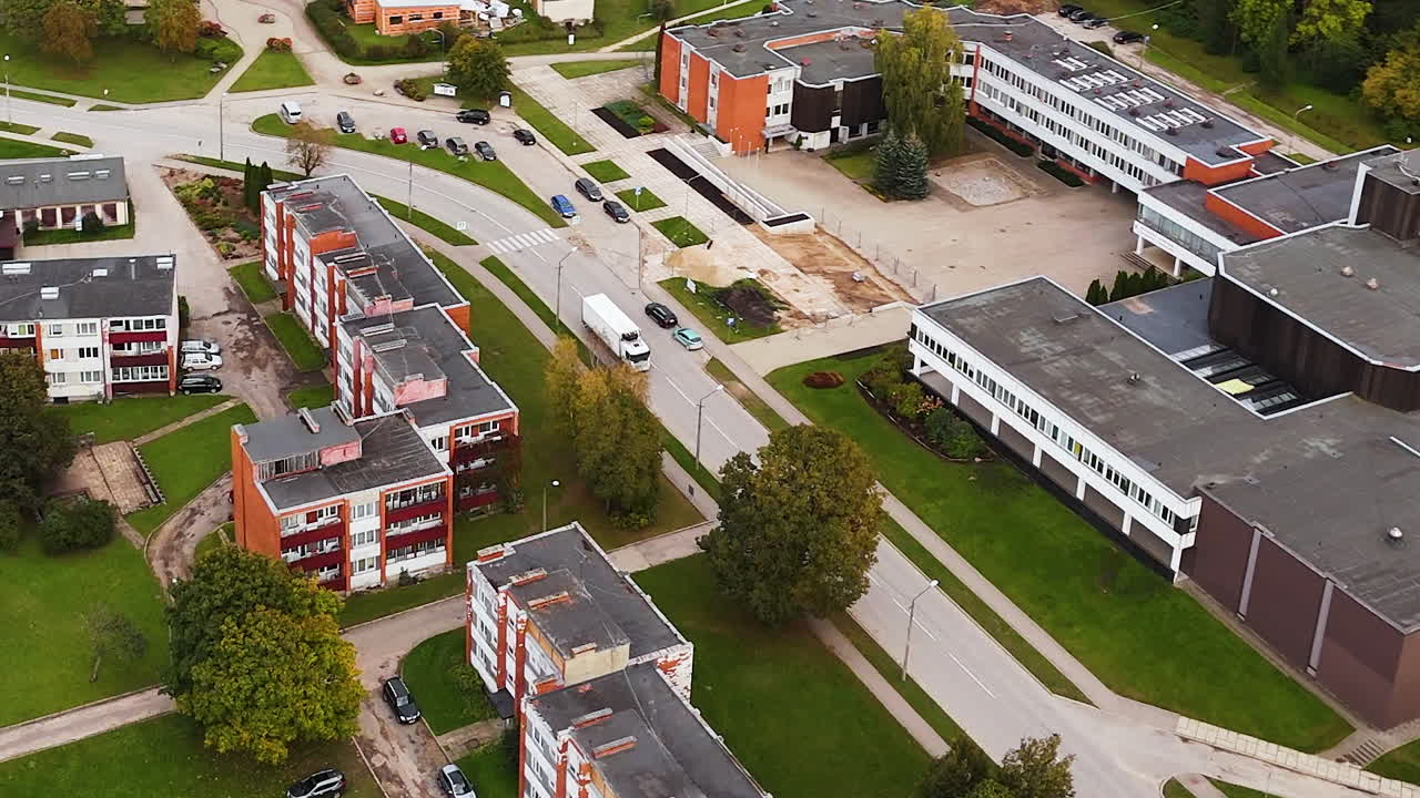 Aerial view of Malpils town layout with fall-colored trees and residential buildings.