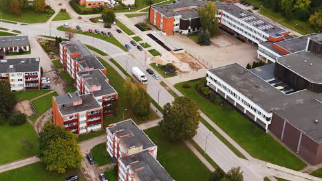aerial view of malpils town layout with fall-colored trees and residential buildings.