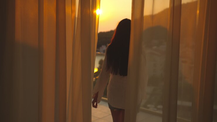 Woman Enjoying Sunset View from Balcony