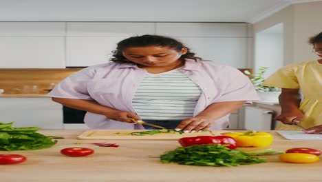 woman chopping vegetables in a kitchen