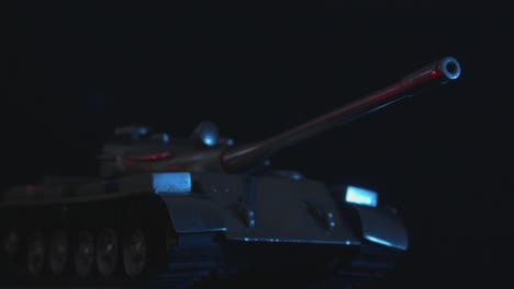 close up of metal toy tank in the dark