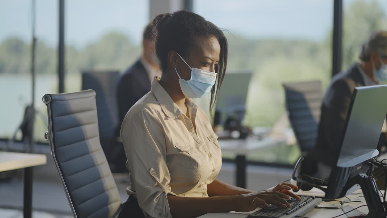 Woman working from home at a call center wearing a mask