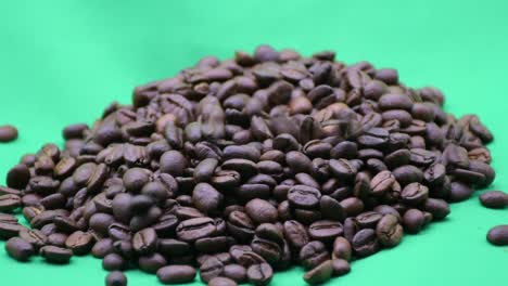 coffee beans slowly falling on a green screen