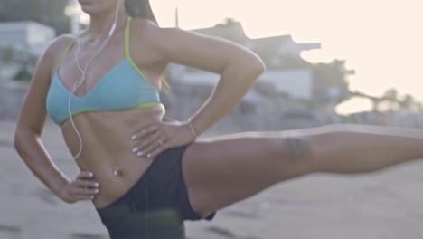 woman exercising legs on beach