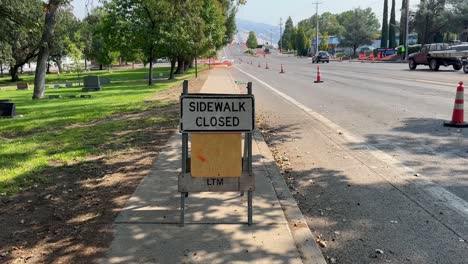 A construction sign closing off a sidewalk in Ashland, Oregon