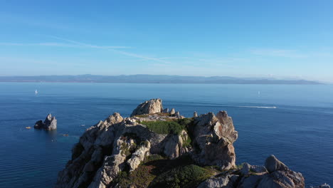 man standing on a cliff cap medes porquerolles aerial shot summer hyeres island