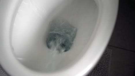 Flushing-toilet-water-in-white-bowl