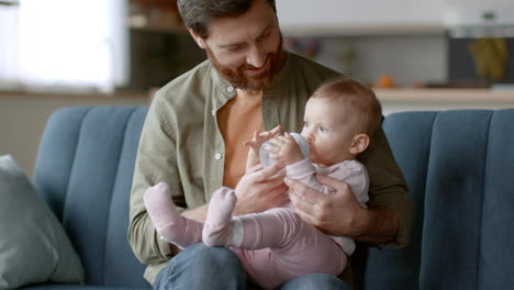 father feeding his baby daughter
