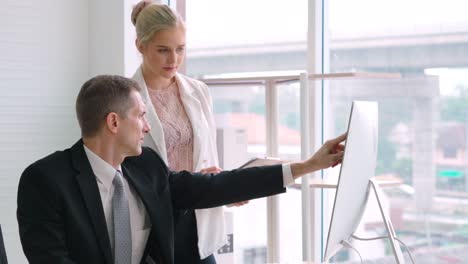 two business people talk project strategy at office