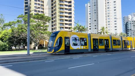 tram travels through city with skyscrapers and vehicles