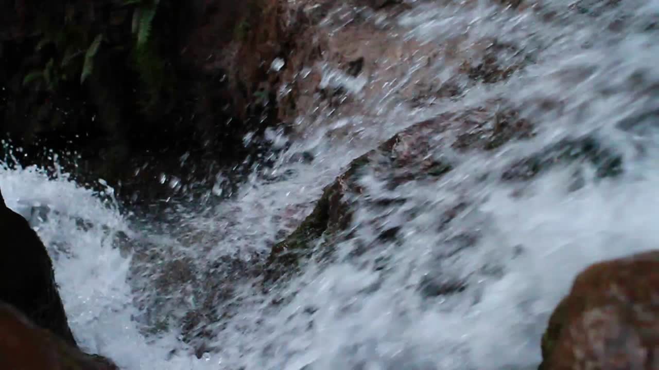 Looking down waterfall as water rushes over the edge