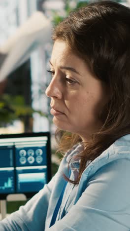 vertical video stressed worker in office sights, burdened by too many documents to review
