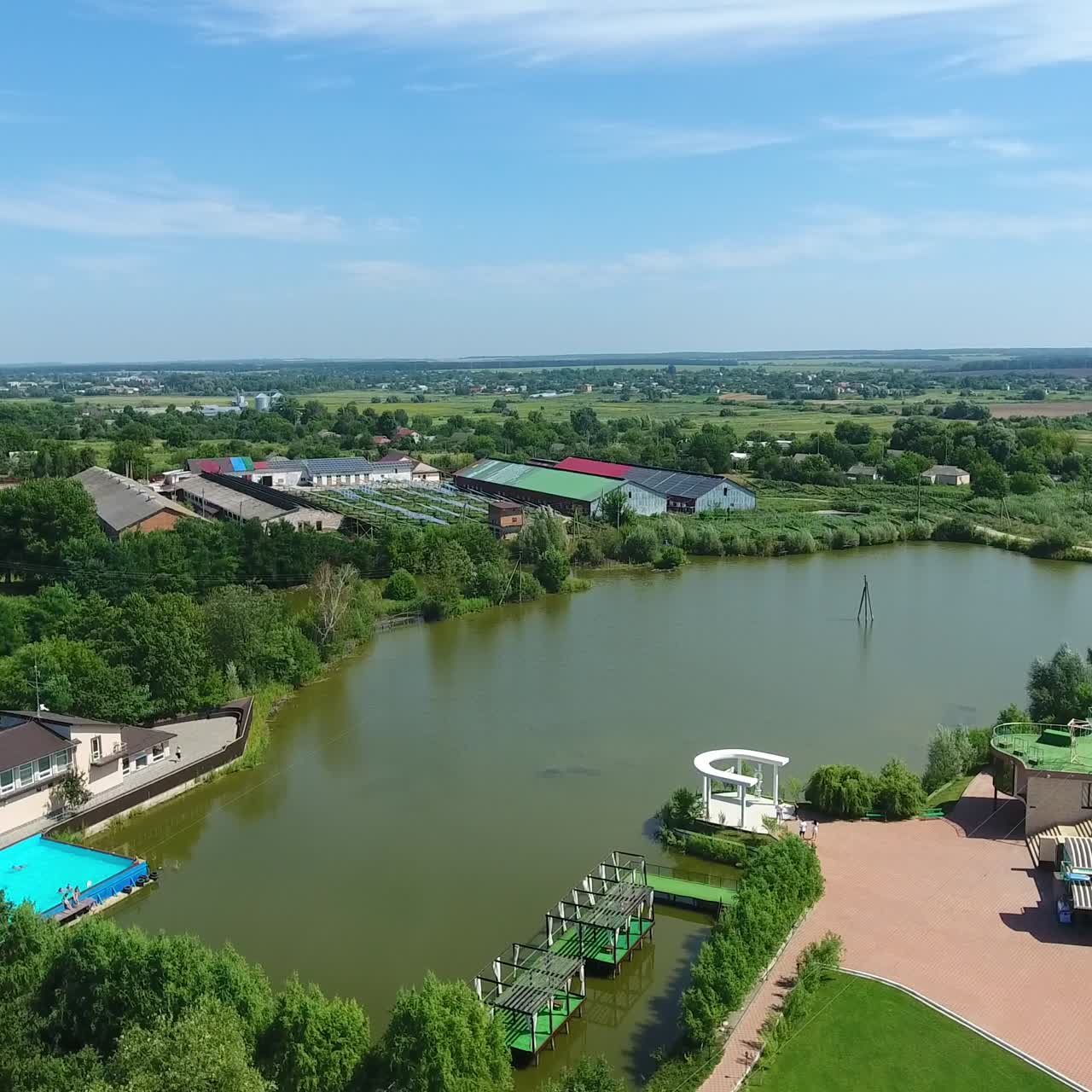 Beautiful recreational area in the countryside. Well-kept territory with cute buildings and little pond inside. Top view