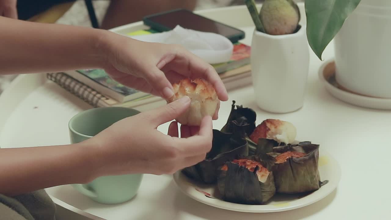 Person enjoying a delicious sticky rice dessert