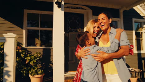 a happy family on their home porch, including children and adults, sharing moments of joy and affection