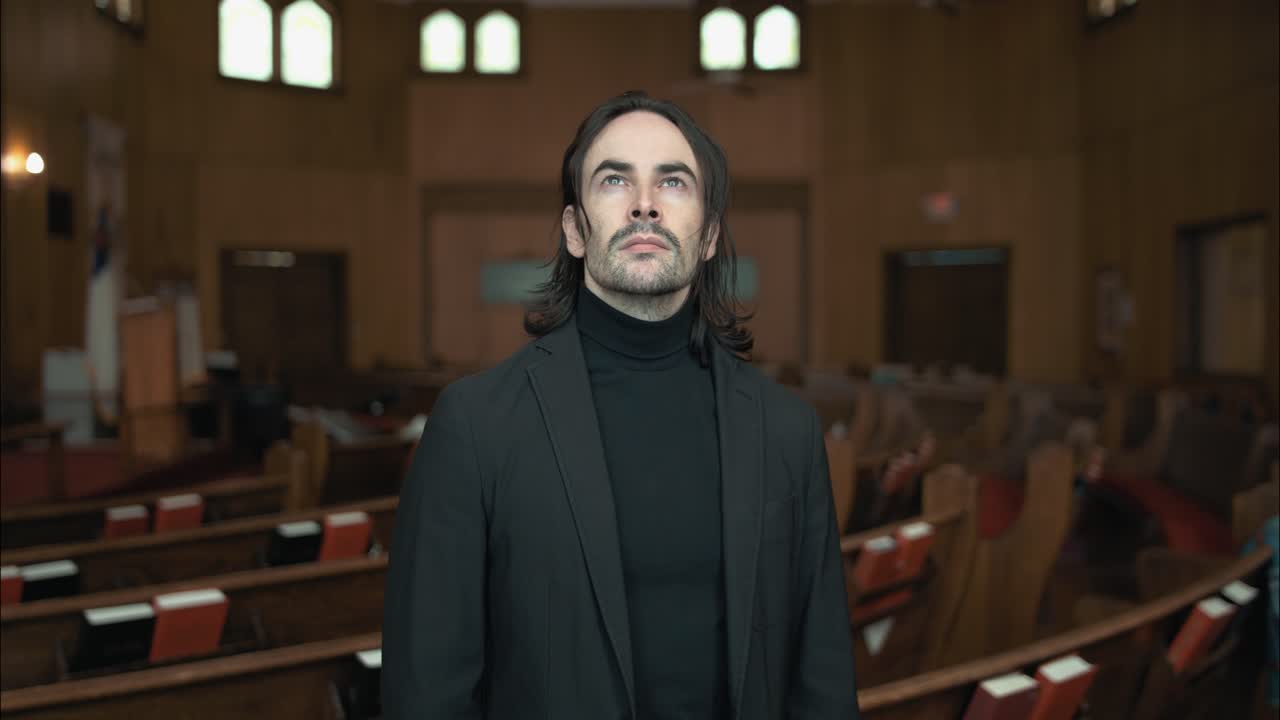 A Christian man, priest, preacher, pastor in spiritual reflection and worship while praying inside old church building, creating a cinematic and contemplative mood