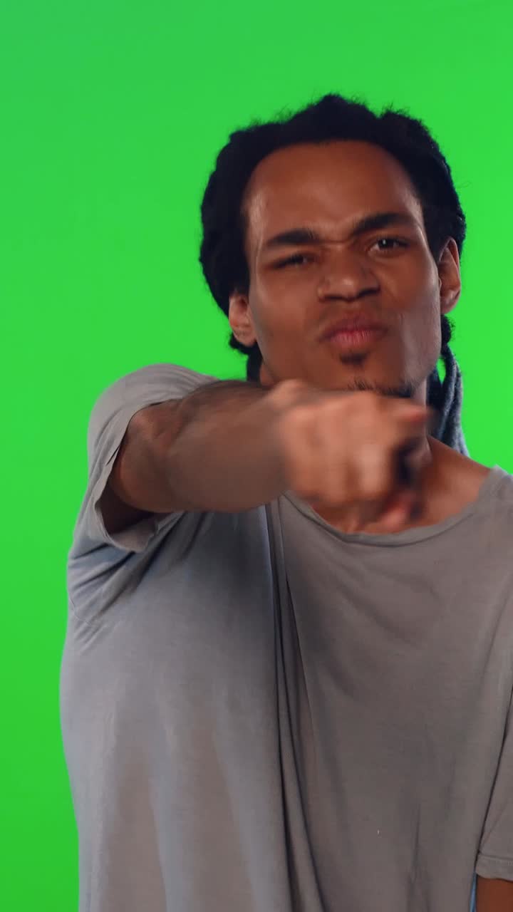 Young Man Expressing Disgust then Dancing and Smiling on Green Screen