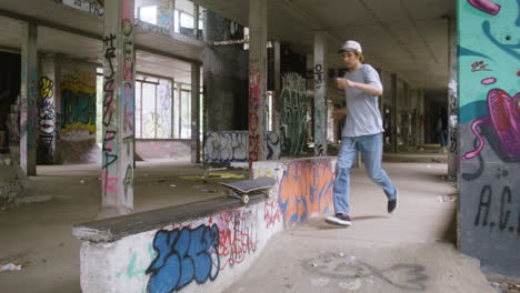 un niño caucásico patinando en un edificio en ruinas.