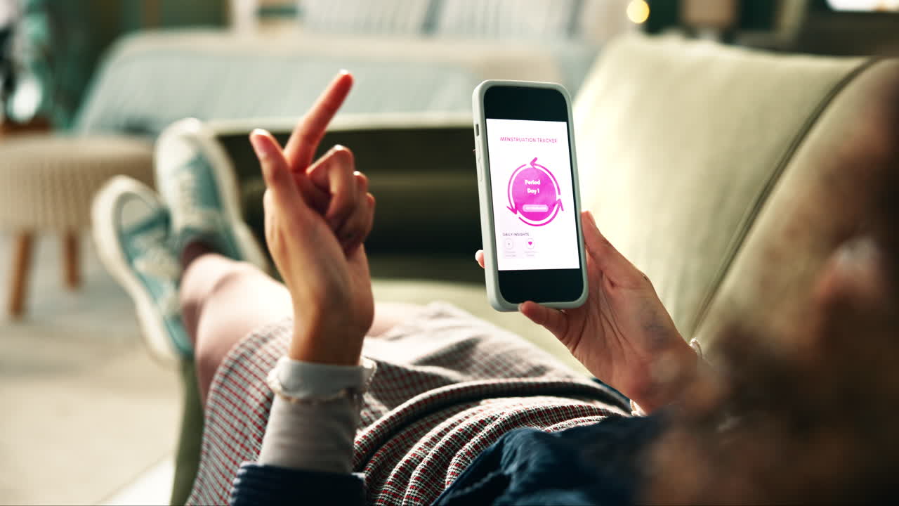 Woman using menstruation tracker app on phone