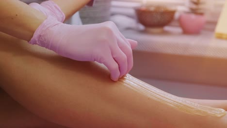 female legs depilation by honey or sugar pasta. sugaring hair removal. beauty concept. sugaring. epilation process. legs.