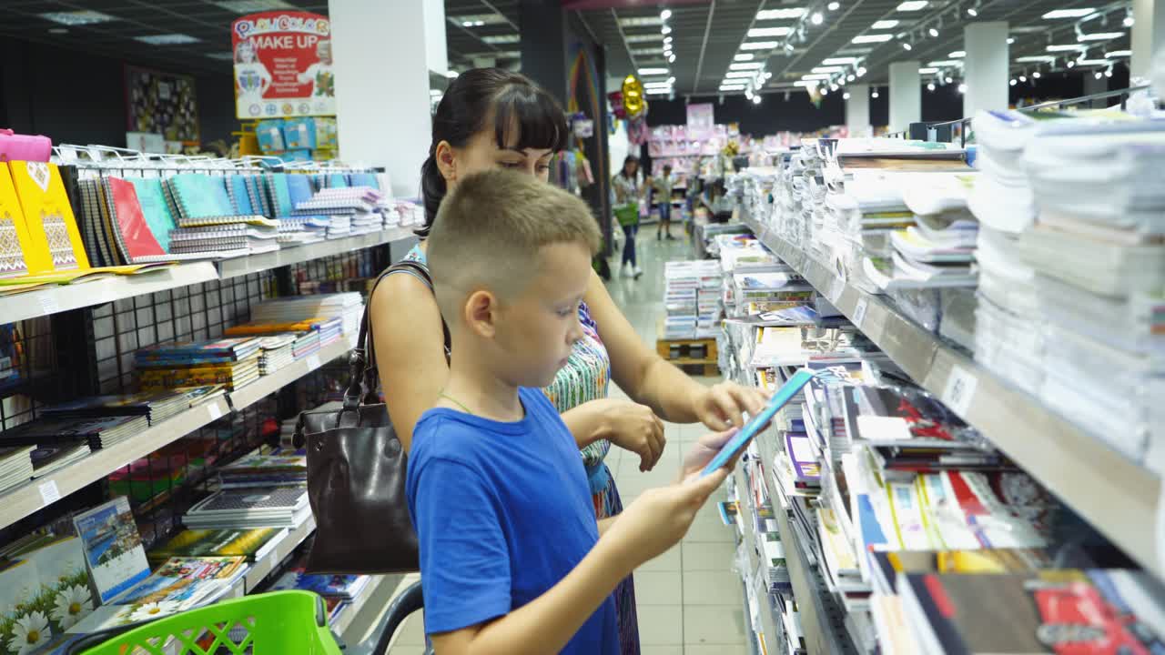 VINNITSA, UKRAINE - AUGUST 20, 2018: child choosing school stationery in store