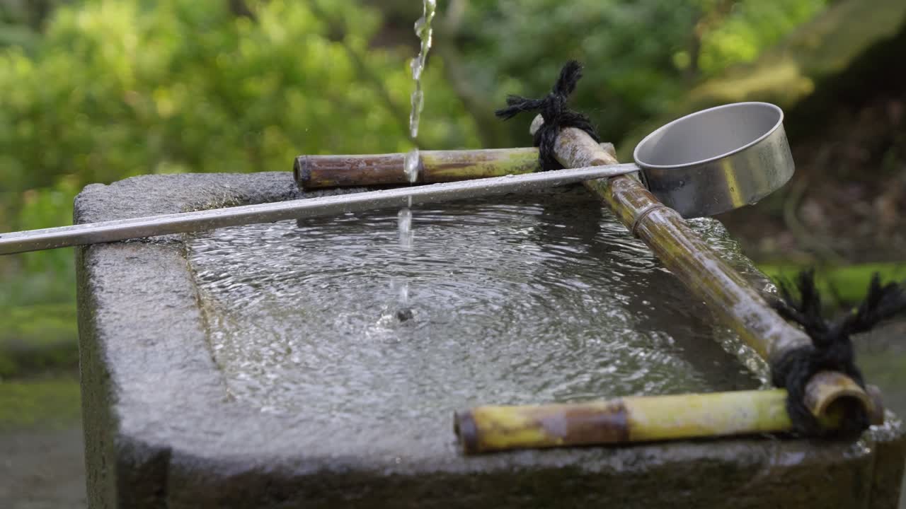 Close up over typical Japanese water ladle at shrine in summer