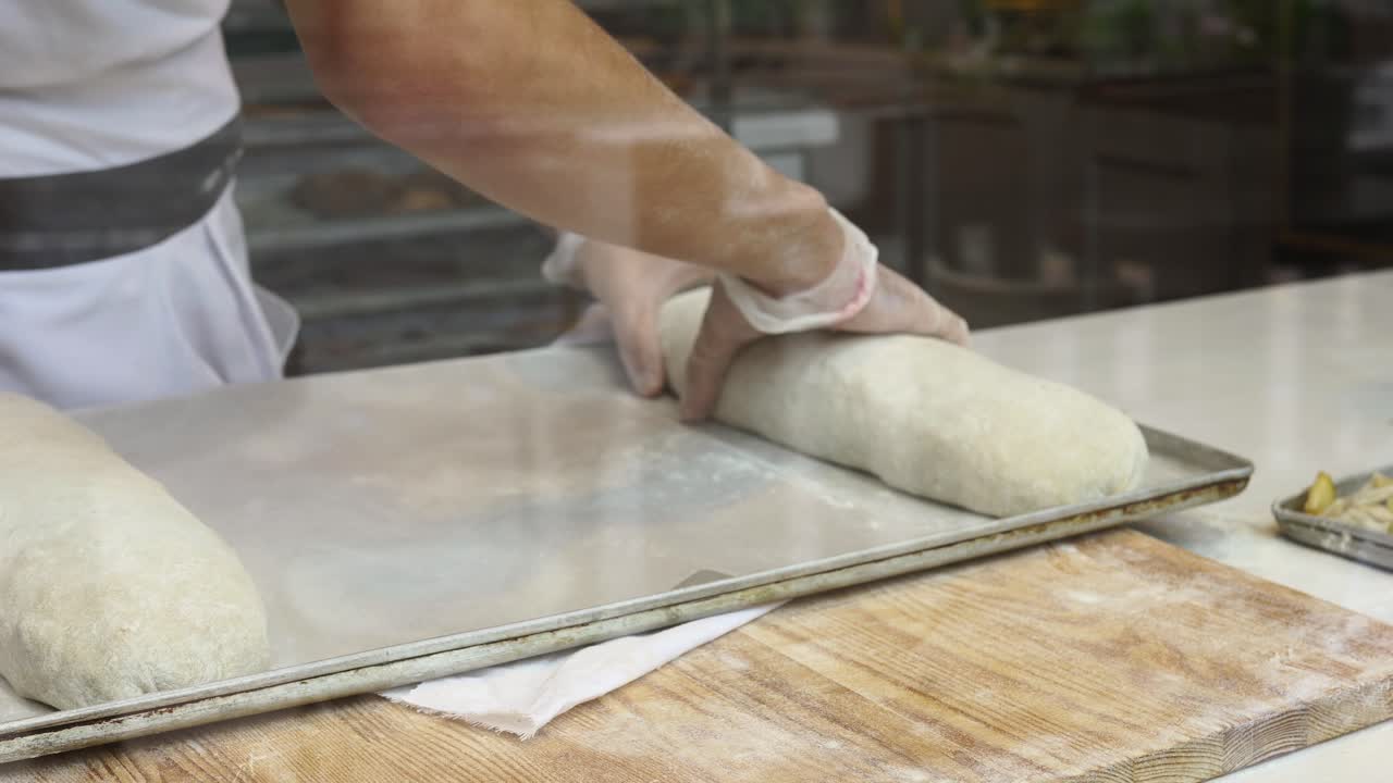Baker Preparing Bread Loaves