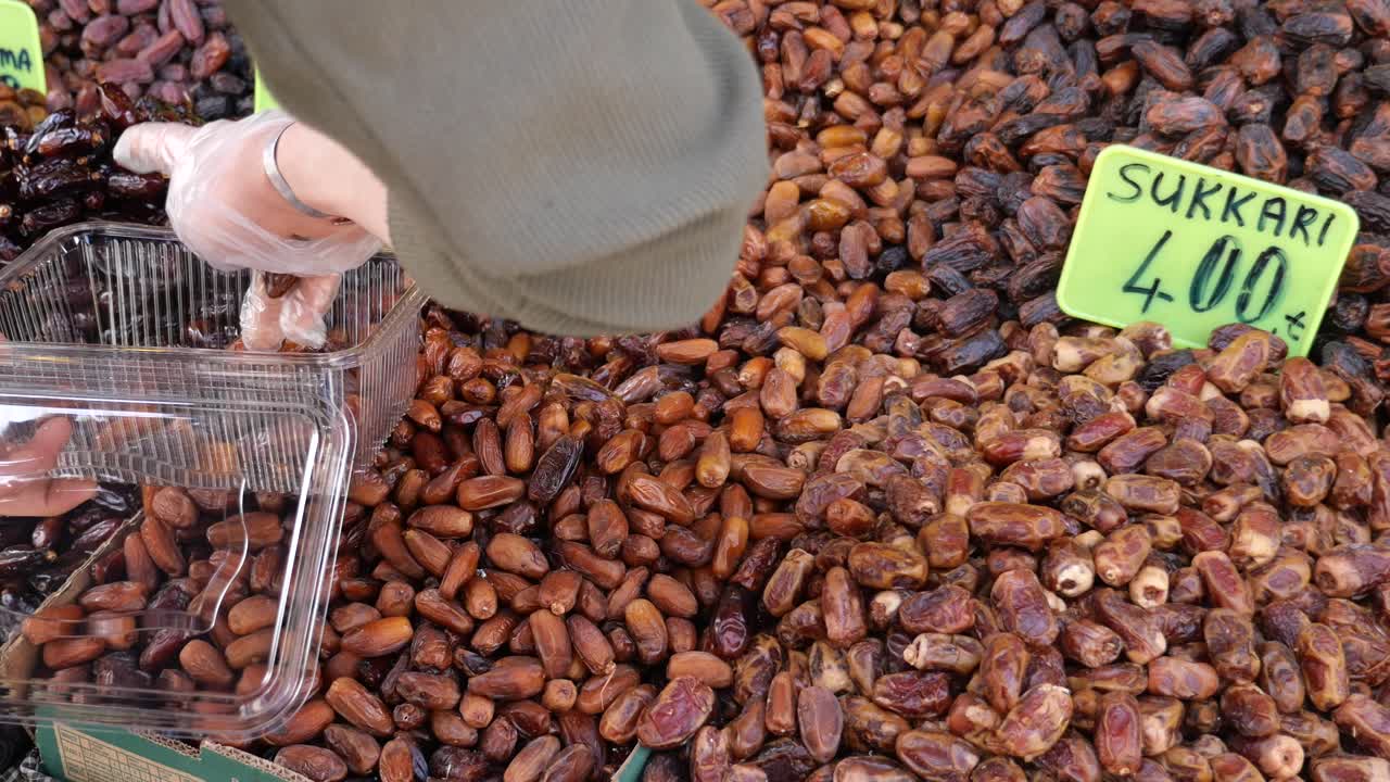 A person buying dates at a Turkish market