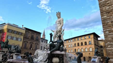 neptune statue with surrounding buildings and sky