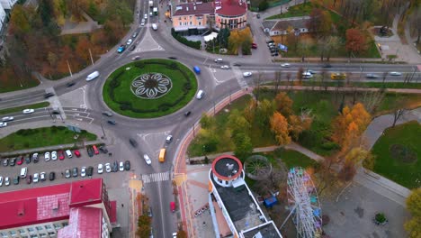 4k aerial view timelapse of roundabout road with circular cars in small european city