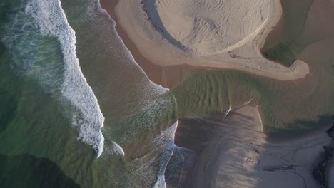 sea waves at the entrance of currimundi creek in wurtulla, queensland, australia