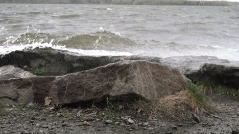 stormy lake waves crashing against rocks