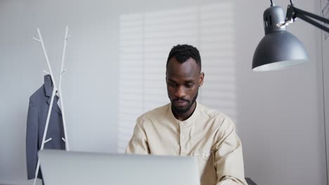 man working on laptop in modern office