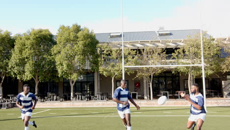 playing rugby on field, african american men in sports uniforms running and practicing teamwork