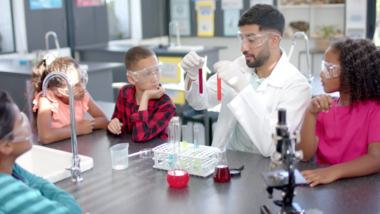 In a school laboratory, a group of students watches intently