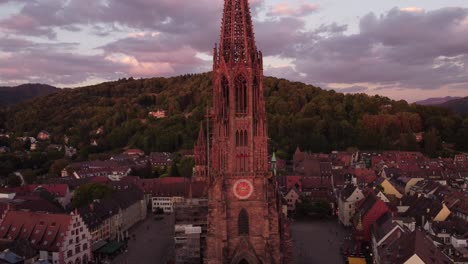 shooting from a drone, view of the freiburg cathedral in the direction of the hill opposite the city
