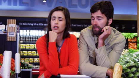 couple ignoring each other in organic section